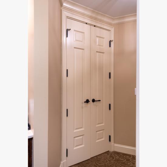 A pair of TS3100 doors in MDF with Roman Ogee sticking and Scoop (B) panel lead to the bathroom suite.