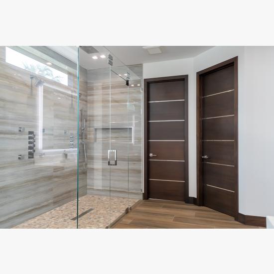 This master bath features TMIR6000 doors in mahogany with ½" bright stainless steel inlay. Builder provided stain finish.