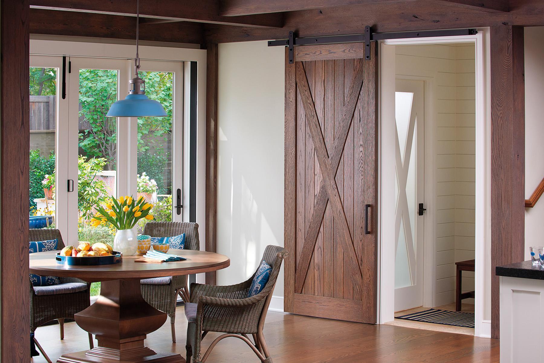 dining room with interior barn door and glass panel door