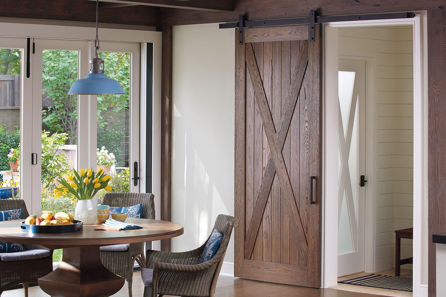 dining room with interior wooden barn door and glass panel door