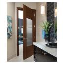 A TM9250 door, in walnut with Nutmeg stain and Groove glass, divides a bathroom from this contemporary study.