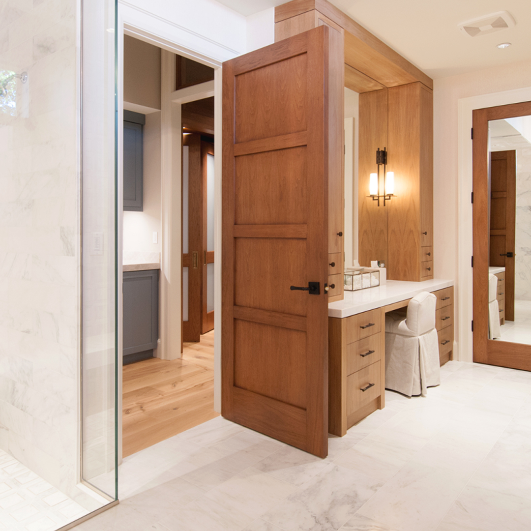 A wooden TS4100 door in a luxury bathroom.