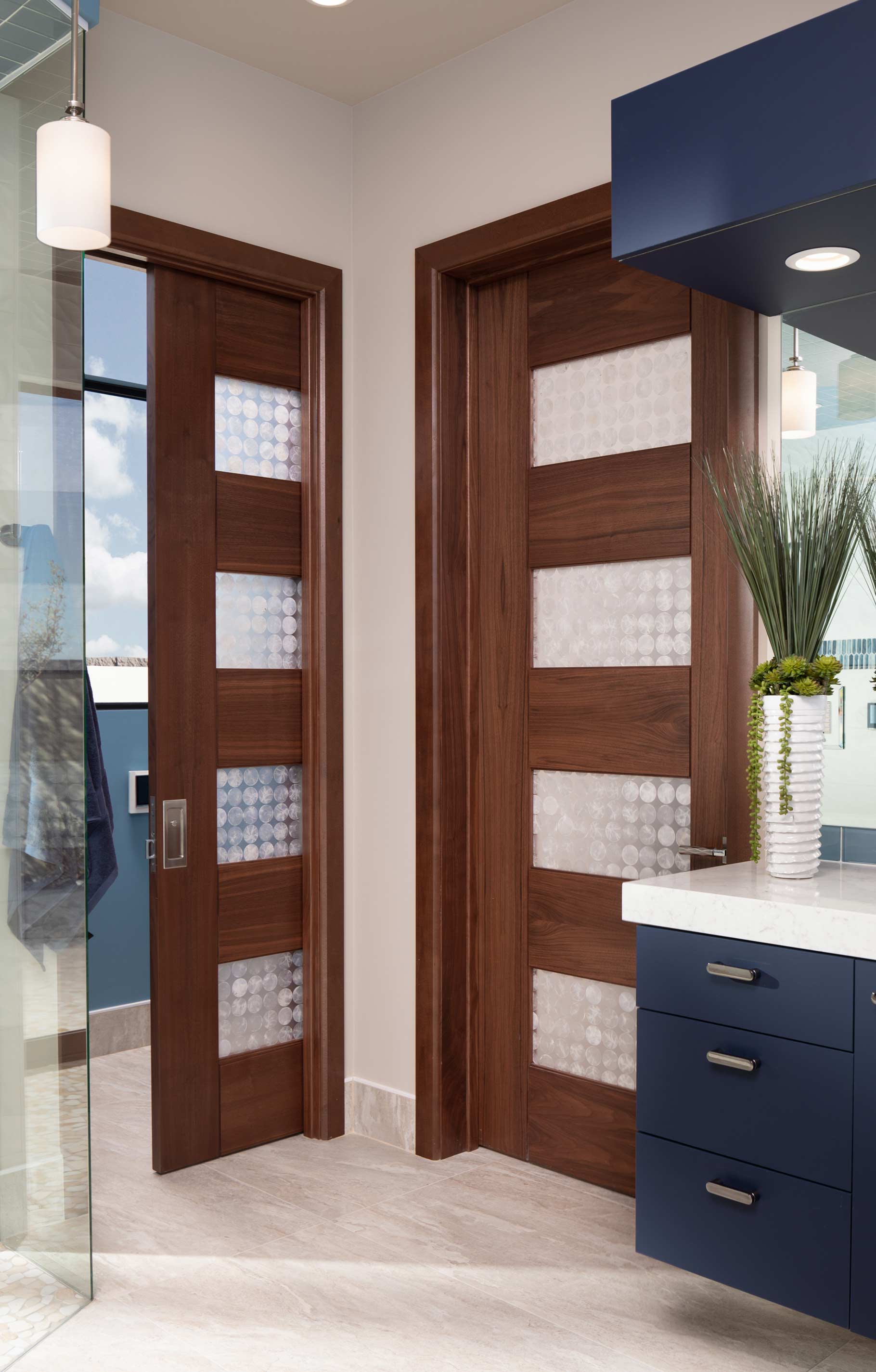 TM9160 pair of walnut contemporary doors in a bathroom setting.