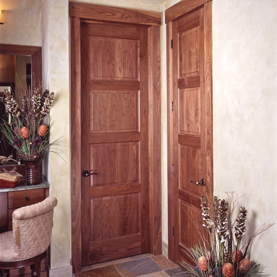 A corner with two wooden TS4100 doors next to each other.