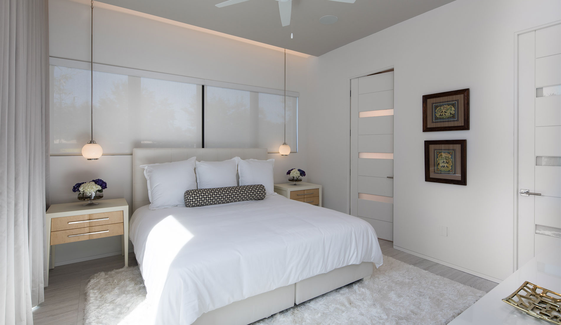 TM9320 doors with White Lami glass add a modern finish to this guest room 