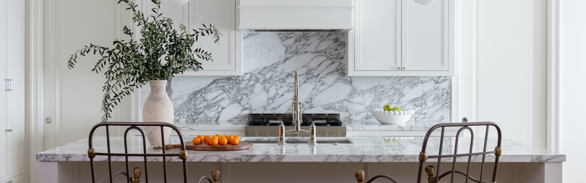 Detail of transitional kitchen in white withh grey marble accents