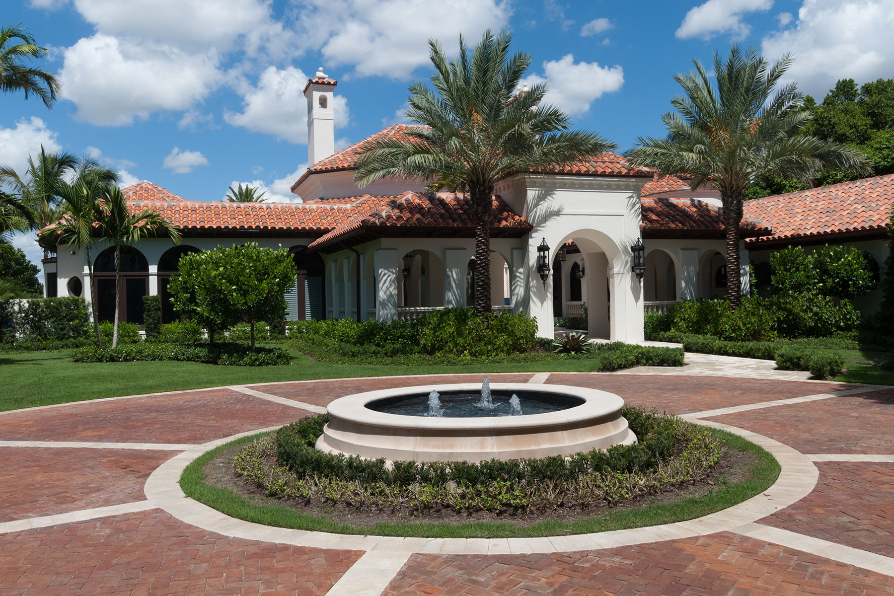 A round drive greets visitors to this renovated Palm Beach estate