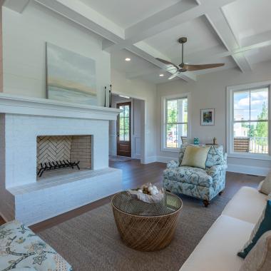 A large living room offers a view of a FL810 entry door in Cherry with Hazelnut finish.