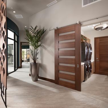 A TM9350 in walnut with Nutmeg stain and Bamboo Rings resin conceals the laundry room from the dining room. TM9000 in back.