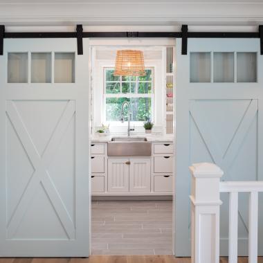 Pair of PL143 barn doors in MDF with clear glass, Square Stick (SS) sticking and custom plant-on accents.