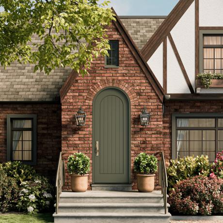 Radius top VG1040-ES401 Resilient Wood Entry System with vertical plank detailing and Multi-Point Lock hardware on a Tudor-inspired brick home.