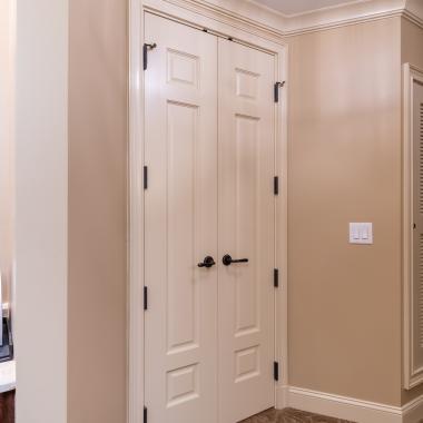 A pair of TS3100 doors in MDF with Roman Ogee sticking and Scoop (B) panel lead to the bathroom suite.