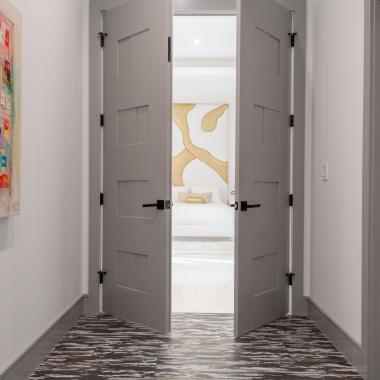 A pair of TM9420 doors in MDF open to the master bedroom.