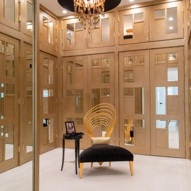 The designer added glamour to this walk-in closet by custom applying plant-ons and mirrors to TS3000 doors in MDF.