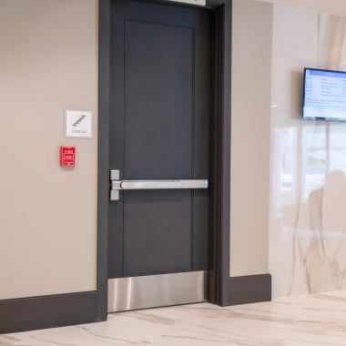 Condominium tower featuring TS1000 doors, in rift sawn white oak with Quirk (QM) moulding and Flat (C) panel in lobby.