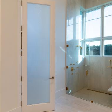 This master bath features 10' tall TS1000 door in MDF with One Step sticking and White Lami glass