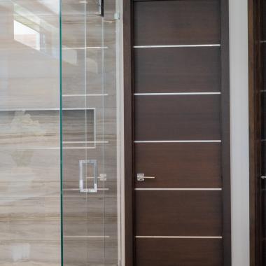 This master bath features TMIR6000 doors in mahogany with ½" bright stainless steel inlay. Builder provided stain finish.