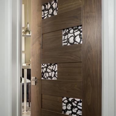 TM13420 in walnut with 3Form® Ponder Dark resin (discontinued) is a focal point in the hallway.