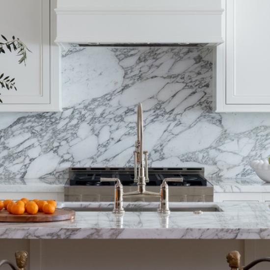 Detail of transitional kitchen in white withh grey marble accents