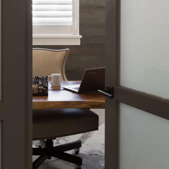 Looking into an office through a pair of TS3000 doors in MDF with white lami glass