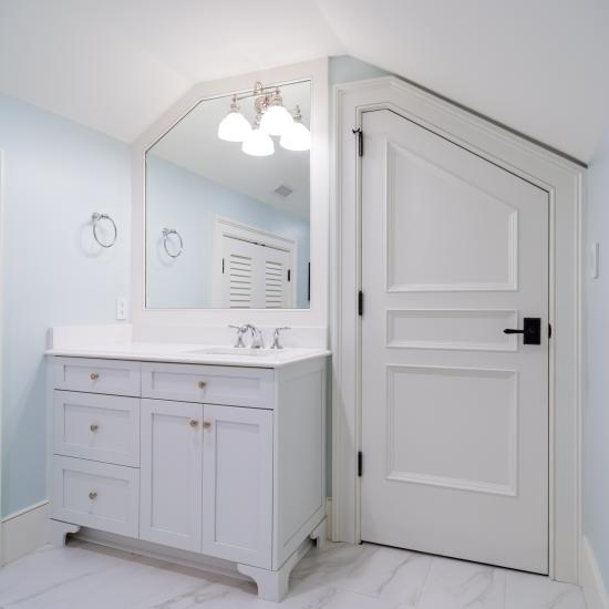 A clipped-corner TS3070 door fits the unique ceiling of this attic powder room.