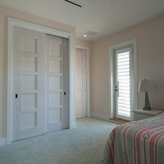 The custom whitewash finish of these birch TM5000 doors ties in with the pastel color scheme of the home.