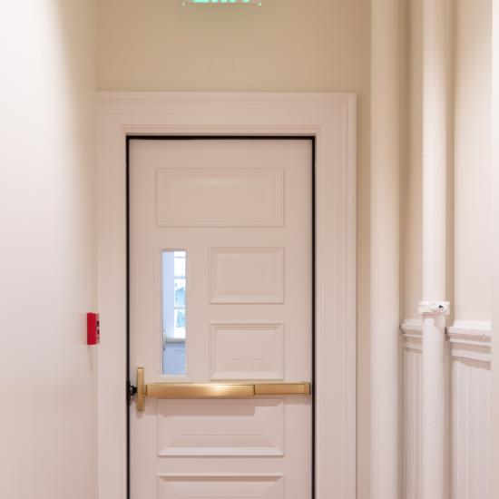 Custom fire-rated door in MDF with fire glass, Bolection (BM) moulding and Senior Raised (E) panel.