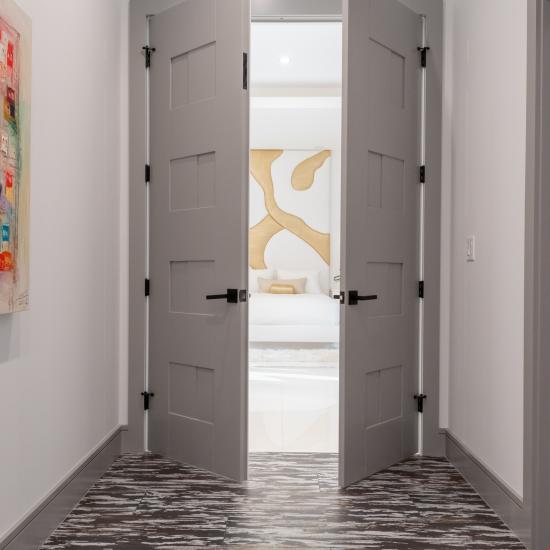 A pair of TM9420 doors in MDF open to the master bedroom.