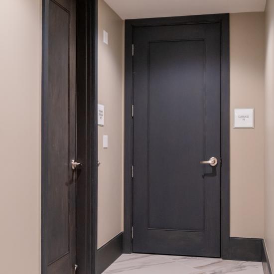 Condominium tower featuring TS1000 doors, in rift sawn white oak with Quirk (QM) moulding and Flat (C) panel in lobby.