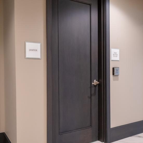 Condominium tower featuring TS1000 doors, in rift sawn white oak with Quirk (QM) moulding and Flat (C) panel in lobby.