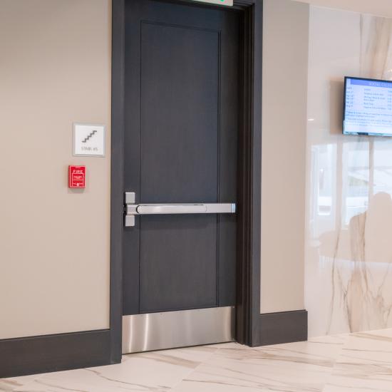 Condominium tower featuring TS1000 doors, in rift sawn white oak with Quirk (QM) moulding and Flat (C) panel in lobby.