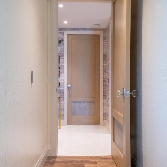 Modified TS2210 doors, in wire-brushed plain sawn white oak with customer applied ceruse finish and Shagreen Grey Oyster leather.