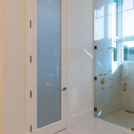 This master bath features 10' tall TS1000 door in MDF with One Step sticking and White Lami glass