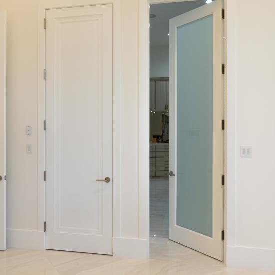 This master bath features 10' tall TS1000 panel doors in MDF with Miracle (MR) moulding and glass doors with One Step sticking and White Lami glass.