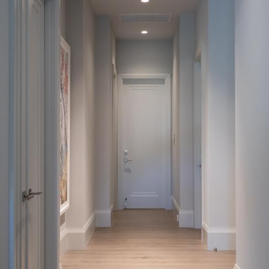 A hallway with TS1000 doors, in MDF with Miracle (MR) moulding and flat (C) panel, leads to the garage.