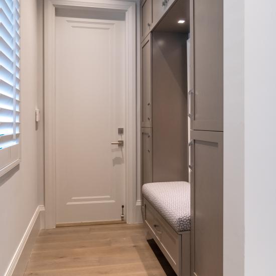 A mudroom features TS1000 doors in MDF with Miracle (MR) moulding and Flat (C) panel.