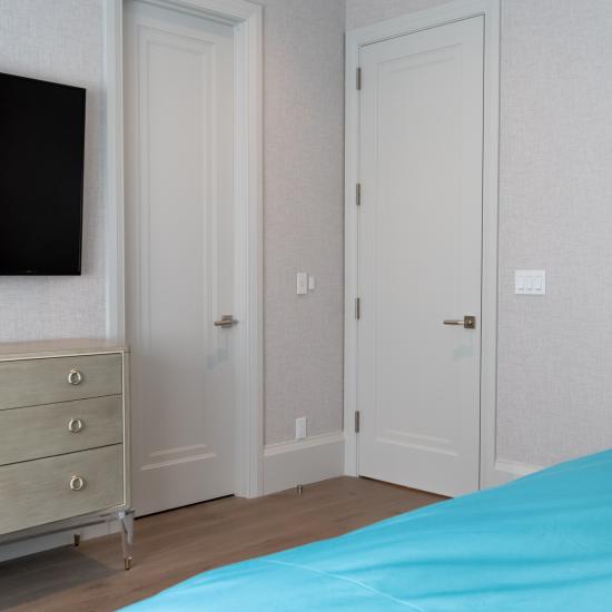 A guest room features TS1000 doors in MDF with Miracle (MR) moulding and Flat (C) panel.