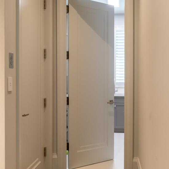 TS1000 doors in MDF with Miracle (MR) moulding and Flat (C) panel are used for both the elevator and laundry room.