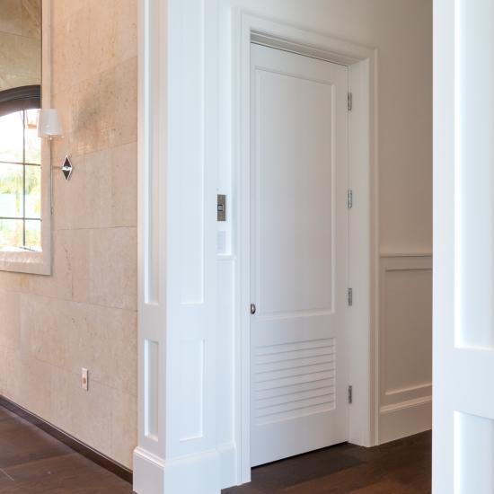 The elevator on this coastal home features a TS2060 in MDF with Roman Ogee (OG) sticking and Raised (A) panel. The bottom panel has been switched to a false louver panel.