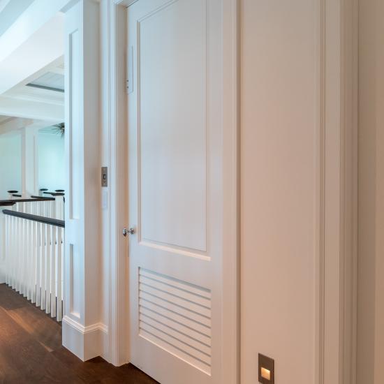 The elevator on this coastal home features a TS2060 in MDF with Roman Ogee (OG) sticking and Raised (A) panel. The bottom panel has been switched to a false louver panel.