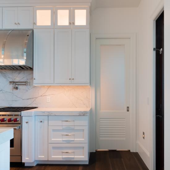 A TS2060 pantry door in MDF with Roman Ogee (OG) sticking, Raised (A) panel and Frosted Glass. The bottom panel has been replaced with false louver panel.