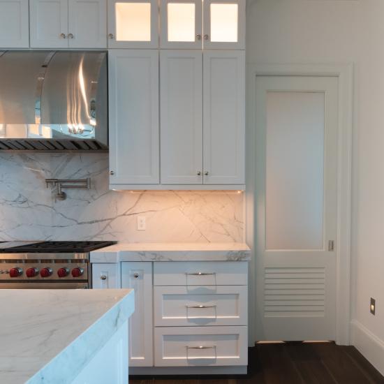 A TS2060 pantry door in MDF with Roman Ogee (OG) sticking, Raised (A) panel and Frosted Glass. The bottom panel has been replaced with false louver panel.