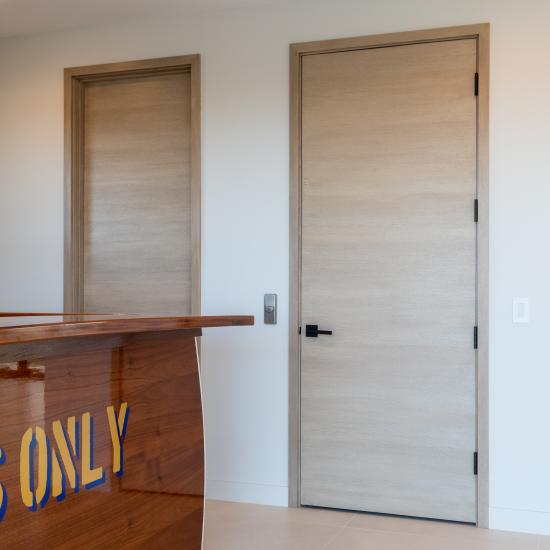 An upstairs lounge features TMF1000 flush doors in quarter sawn white oak with a custom ceruse finish.