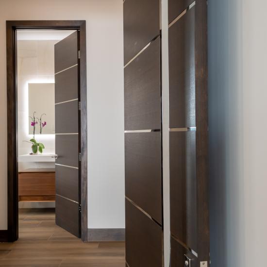 TMIR6000 doors in mahogany with ½" bright stainless steel inlays. Customer stained finish.