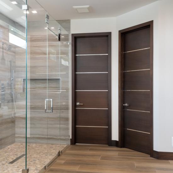 This master bath features TMIR6000 doors in mahogany with ½" bright stainless steel inlay. Builder provided stain finish.