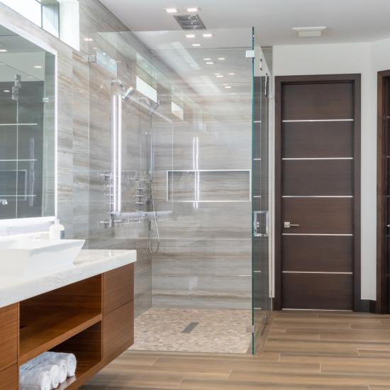 This master bath features TMIR6000 doors in mahogany with ½" bright stainless steel inlay. Builder provided stain finish.