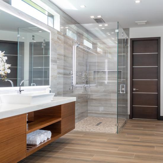 This master bath features TMIR6000 doors in mahogany with ½" bright stainless steel inlay. Builder provided stain finish.