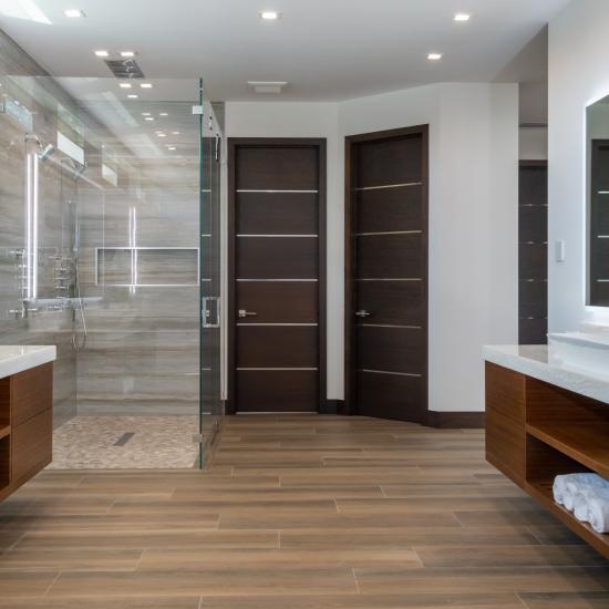 This master bath features TMIR6000 doors in mahogany with ½" bright stainless steel inlay. Builder provided stain finish.