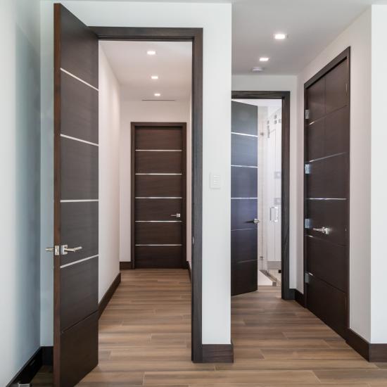 This bedroom features TMIR6000 doors in mahogany with ½" bright stainless steel inlay. Builder provided stain finish.