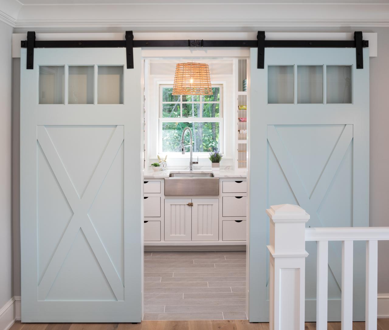 Pair of PL143 barn doors in MDF with clear glass, Square Stick (SS) sticking and custom plant-on accents.